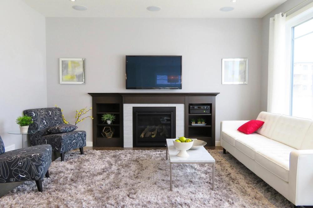 A bright, staged living room with a fireplace